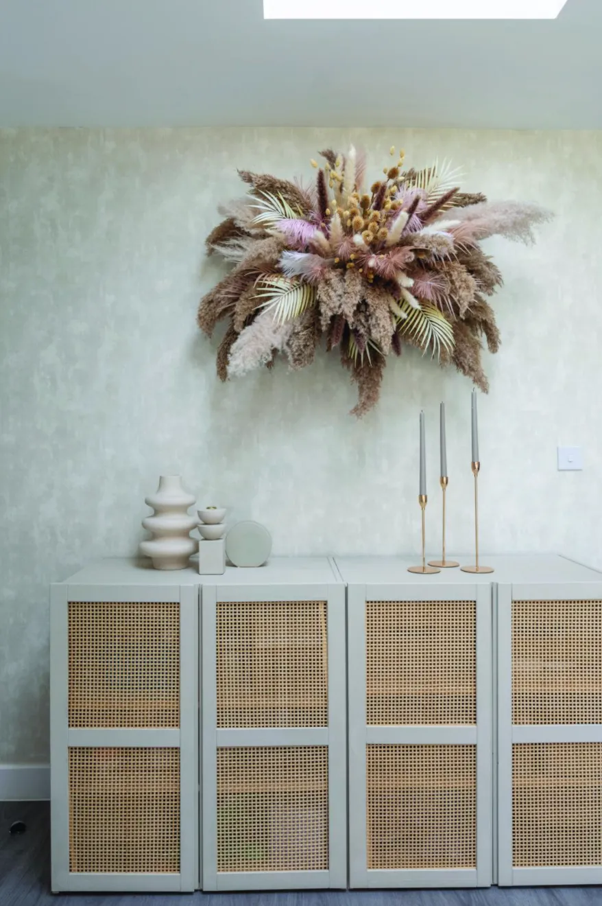 Yooni’s pretty handmade flower cloud is suspended from the ceiling using stick-on hooks. She’s kept the styling on her sideboard – a hacked IKEA Ivar cabinet – minimal and chosen Designers Guild Parchment wallpaper in Silver to showcase it