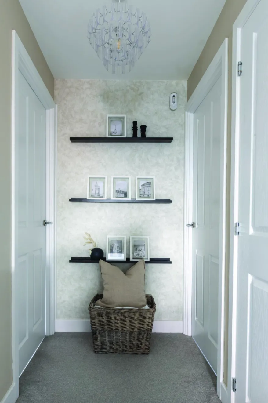 Yooni has made clever use of this wall on the landing with black slimline shelves from B&M, home to her cherished photos that she can add to and change over time