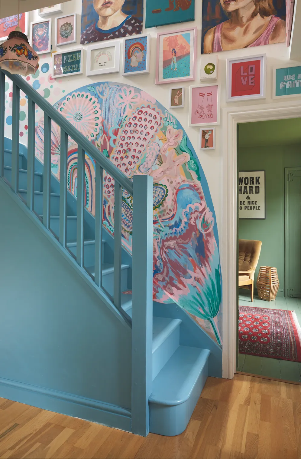 The hallway’s unique mural and staircase, painted in Farrow & Ball’s Stone Blue, reflects the arty vibe of the rest of Jess’s home