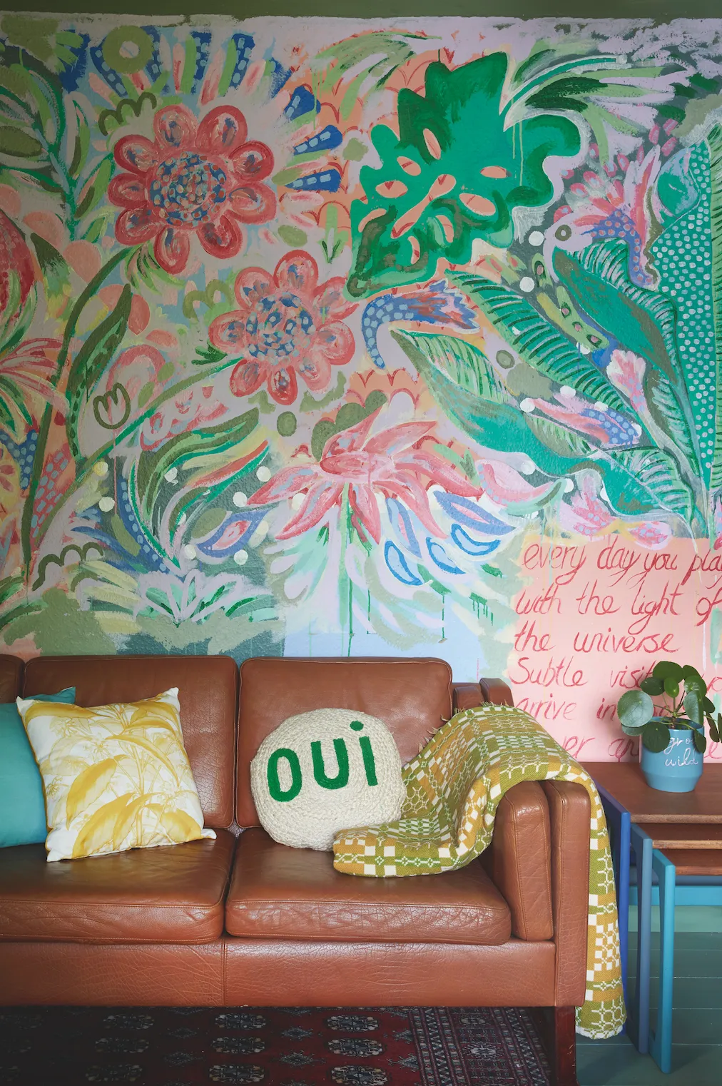 Transforming one of the bungalow’s original bedrooms has given the family a second living space, with a mural in Jess’s signature vibrant style and a nest of tables she upcycled