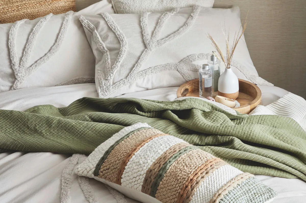 The Edited Life tufted duvet cover set in Sandstone, £65; Pleated jute cushion, £15; Round bamboo tray, £15; Cork ceramic vase, £7, all Dunelm