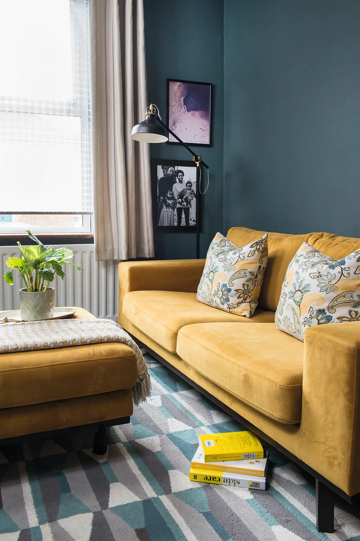 Luckily, Camellia already had the yellow velvet sofa and footstool, which provided just the colour boost her scheme needed. She’s also added a black lamp and framed prints for a chic accent