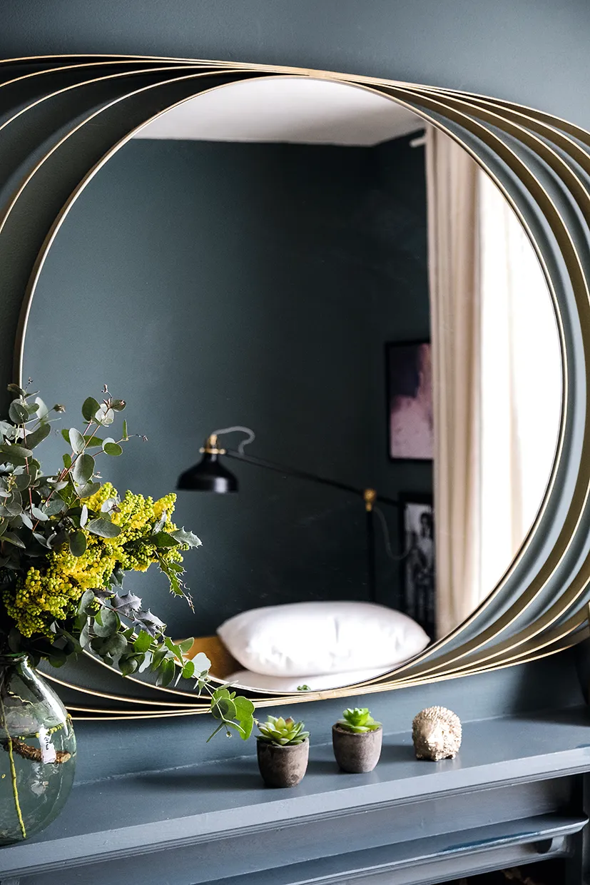 Go for a large-scale mirror to enhance the feeling of light and space in a dark, atmospheric scheme.
