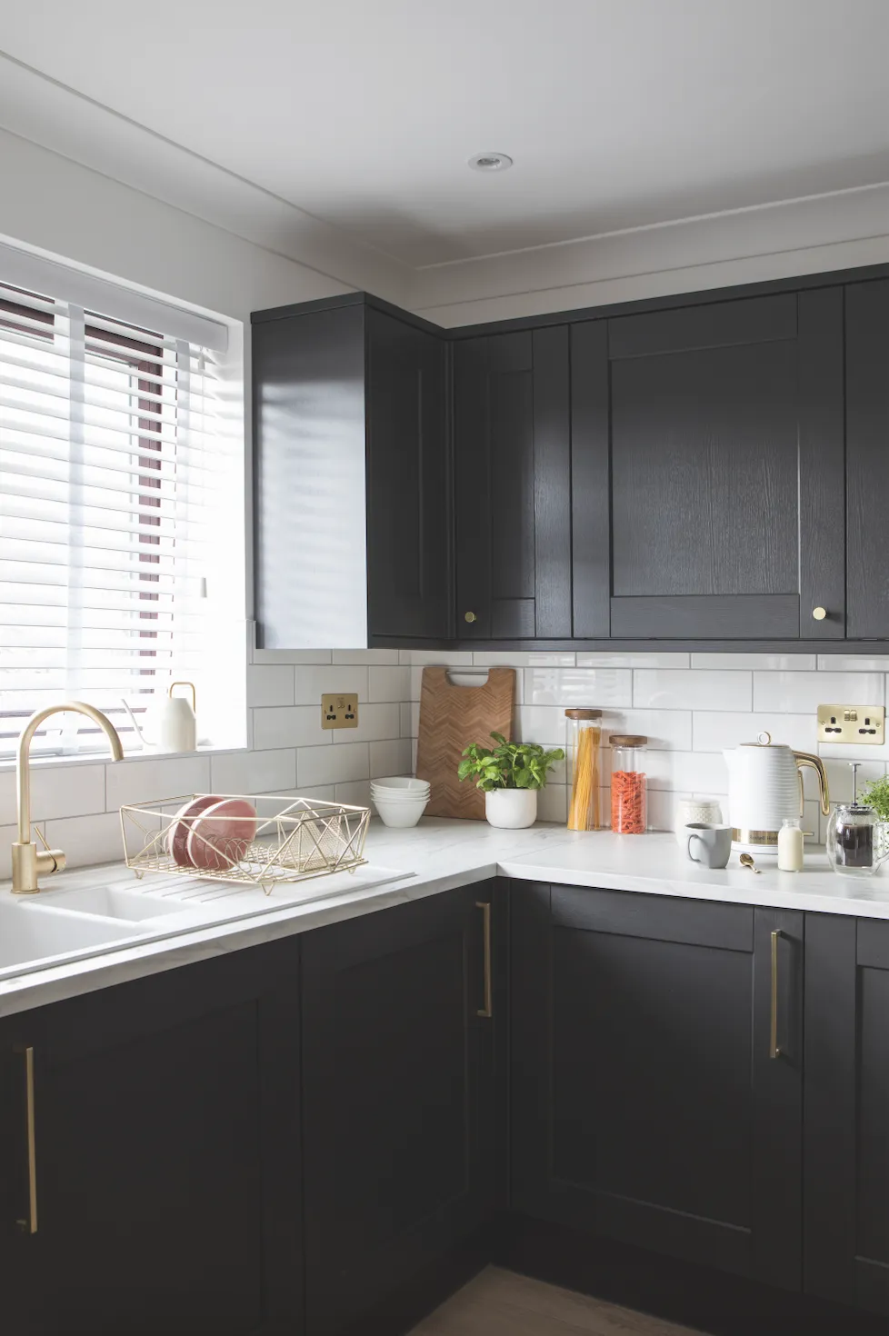 Becca chose metallic fixtures and fittings to lift her dramatic dark kitchen and make it feel upscale. ‘We focused on the details, choosing a brass tap, handles and plug sockets – even the radiator has brass fittings,’ Becca explains