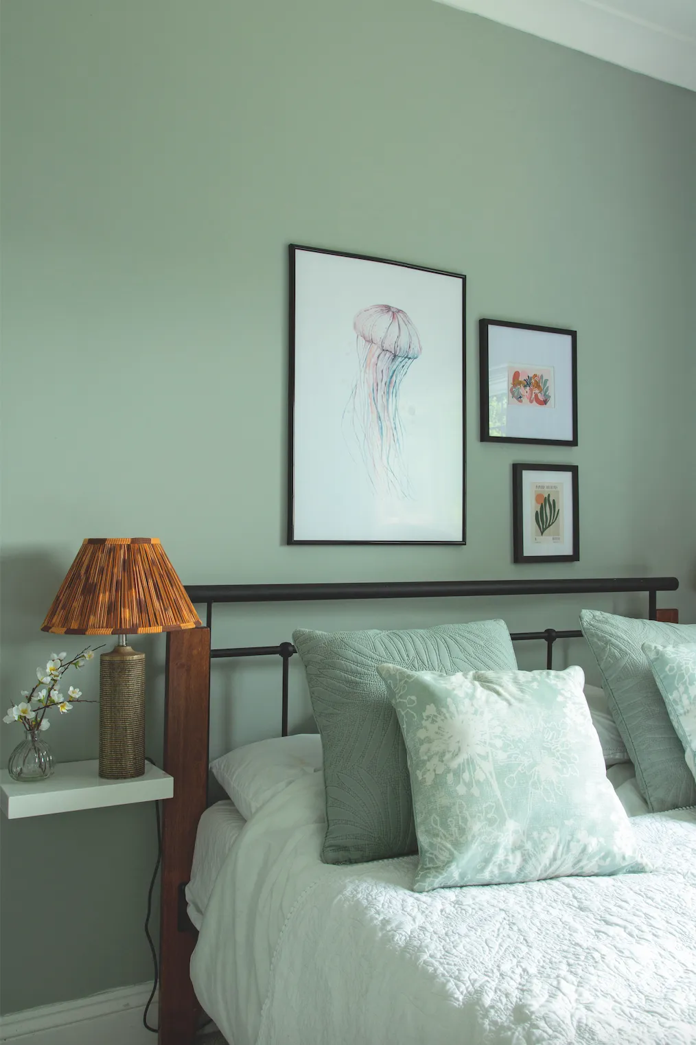Jade wanted a restful feel in the guest room, so she went for a muted grey-green on the walls. She’s pepped it up with prints and burnt orange lampshades, which really add a playful and colourful pop to the cool green