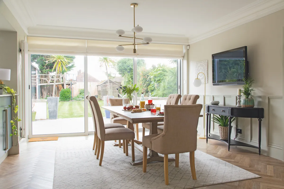 To create a distinct dining area, Jade has zoned the space with a large rug. Light-boosting beige and taupe make the most of the natural daylight streaming in through the patio doors