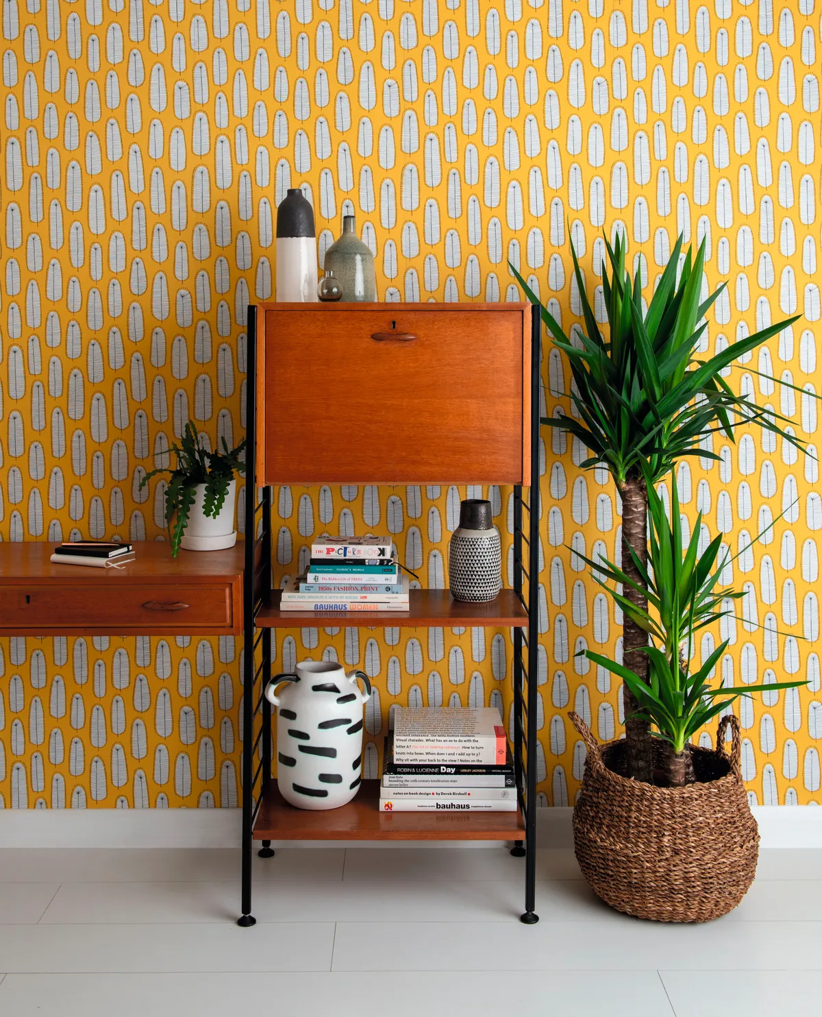 Teak unit in front of yellow wallpapered walls