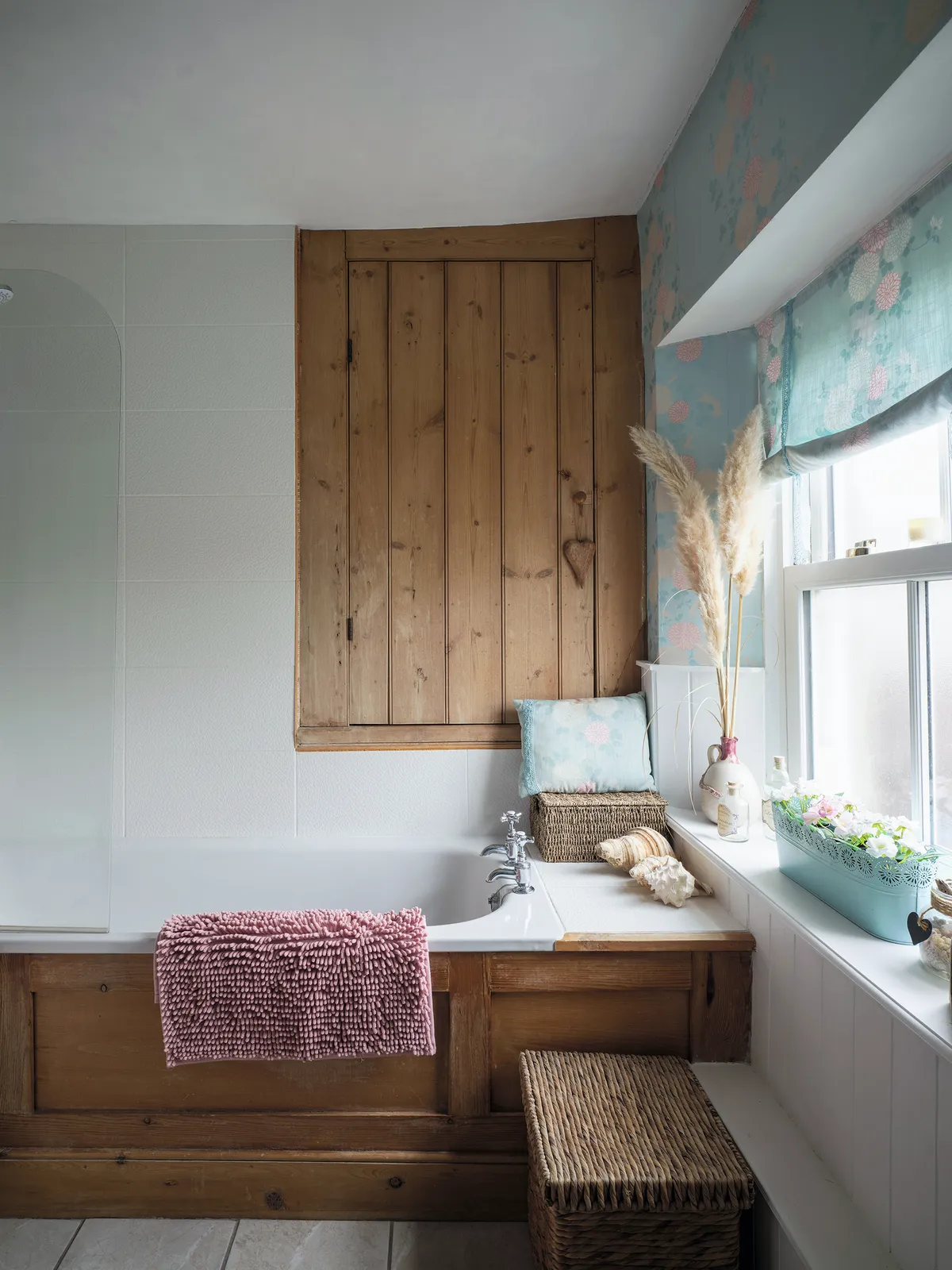 Ali and Gary loved the warm wood tones throughout the house, so they kept a lot of the existing woodwork. In the family bathroom, Ali has lifted it with pastels so it feels light and bright