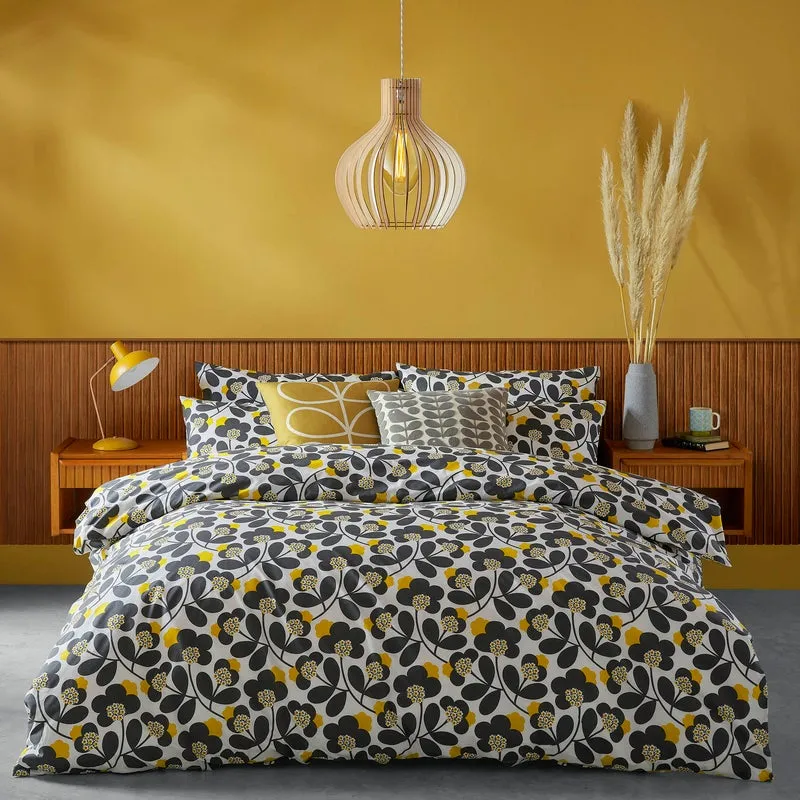 Teal and yellow patterned bedding in a yellow bedroom