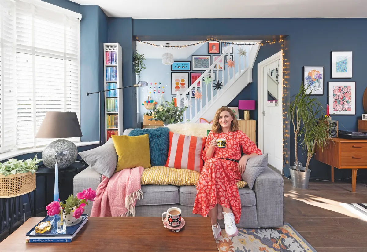 Charlie has grounded her colourful room with navy blue walls, and grey and vintage wooden furniture, so the space feels well thought out. Painting the stairs white, and giving the back wall a splash of lighter blue, stops the room from feeling too dark