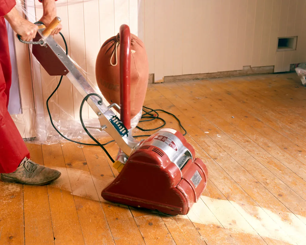 Sanding floor boards with an electric sander