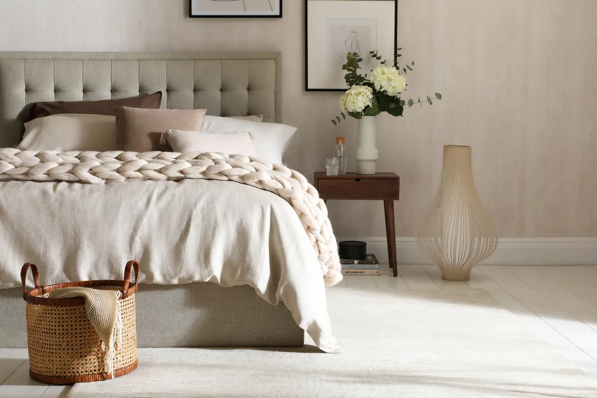 beige bedroom with chunky knitted throw