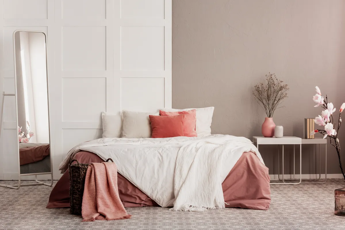 beige bedroom with coral cushions