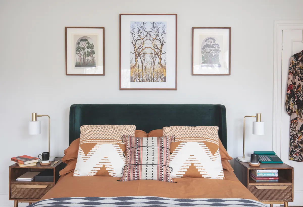 Photographer Jannine loved a photo she took of her favourite tree when walking in lockdown, so has hung it in pride of place over the bed. To match the symmetry of the photo, she took apart an old book she picked up for £5 and framed two pages either side
