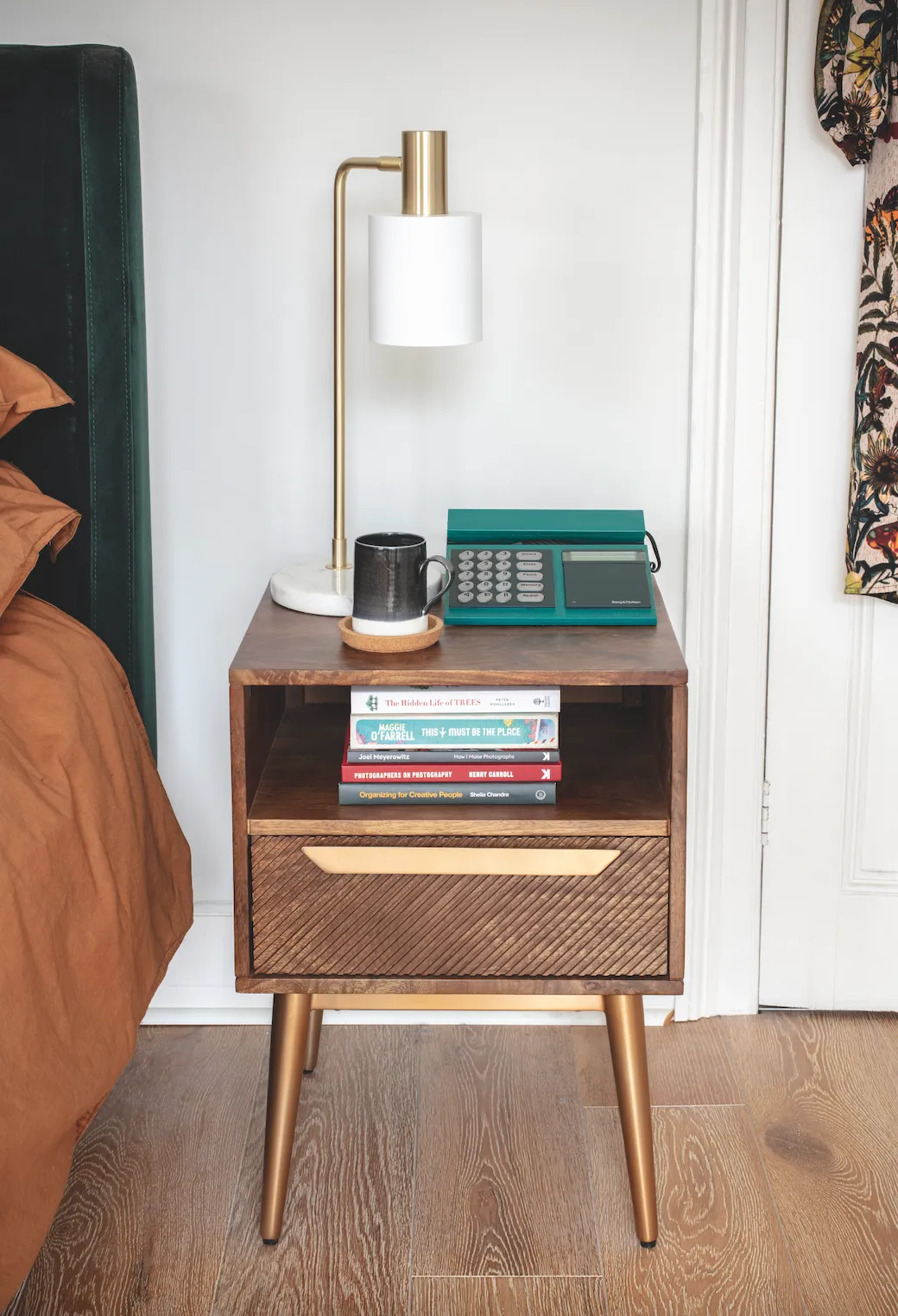 Vintage-look bedside tables are a perfect match for some of Jannine’s special original pieces, like her 1960s telephone. She added white marble and gold lamps to bring a little luxe to the look, as well as soft mood lighting