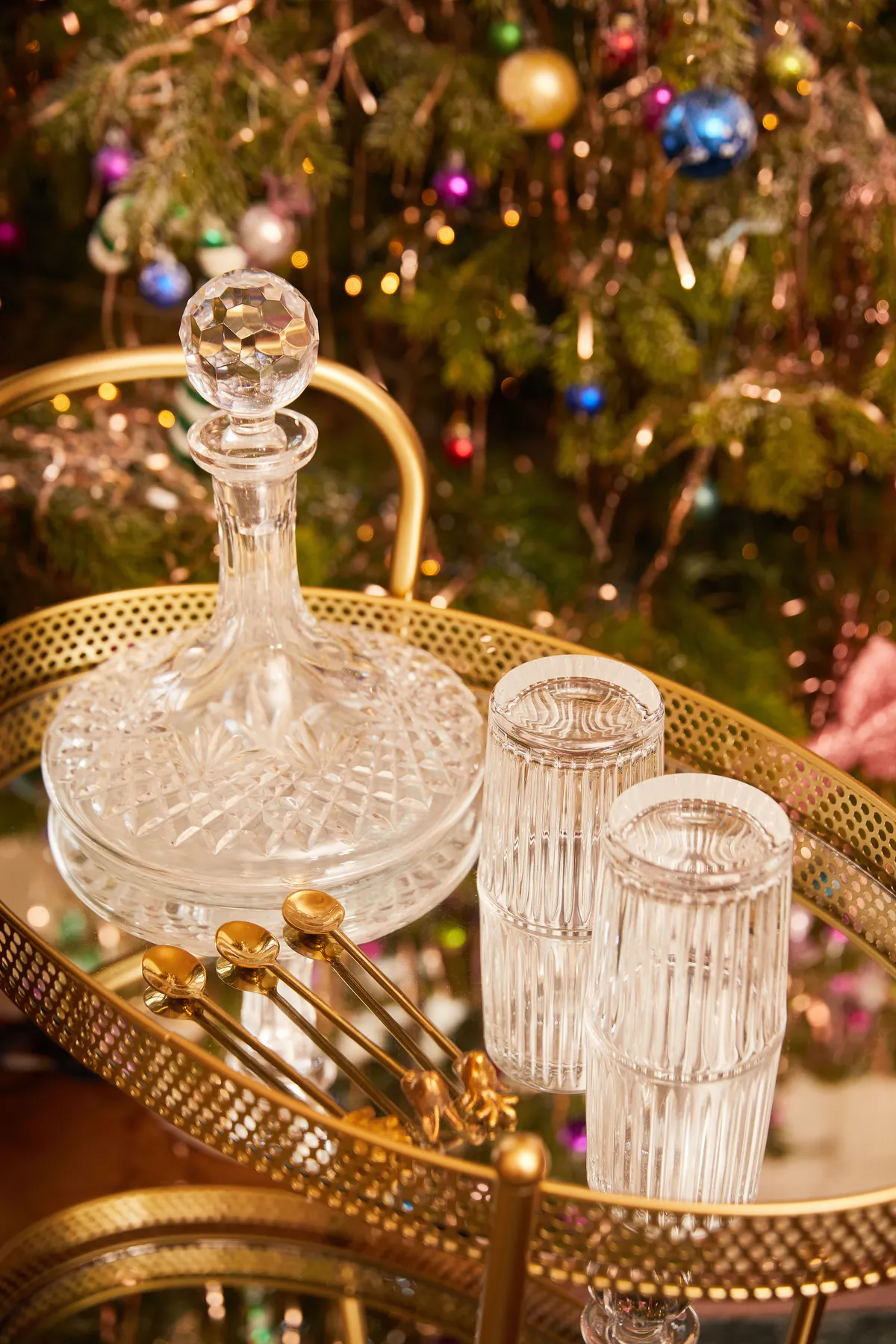 cut crystal glasssware on a gold drinks trolley