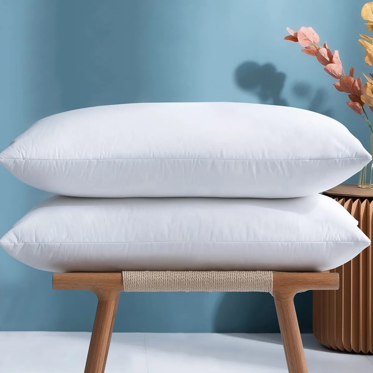 Two feather pillows on stool