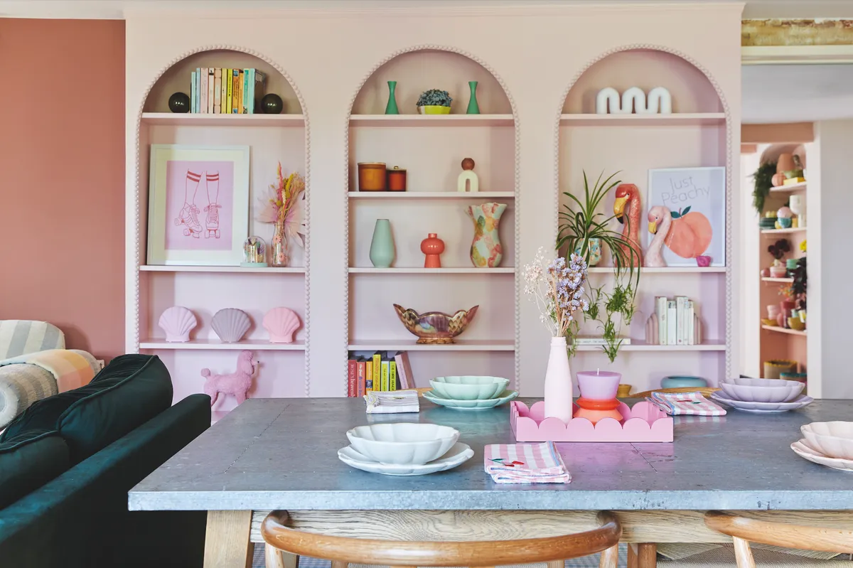 Charlotte has maximised the space in the dining room with floor-to-ceiling arched shelving, painted in pale pink. It’s the perfect place to show off favourite vases, books and knick-knacks