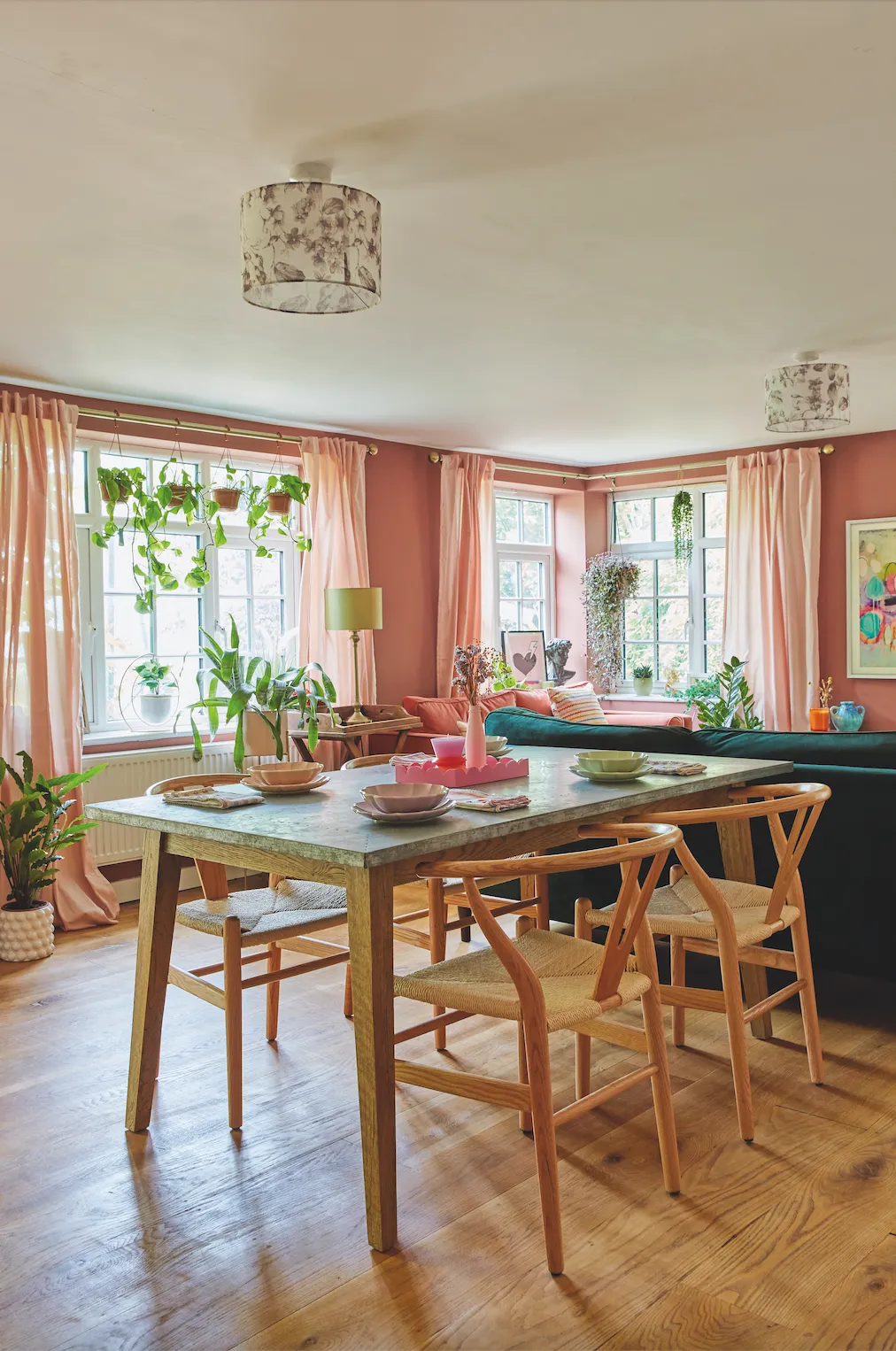 This room is where the family spend most of their time. Decorated in Charlotte’s signature style, with comfy furniture, bold artwork and plenty of houseplants, it’s a big, bright space with different zones for eating and relaxing, so everyone can be in here together while doing different things