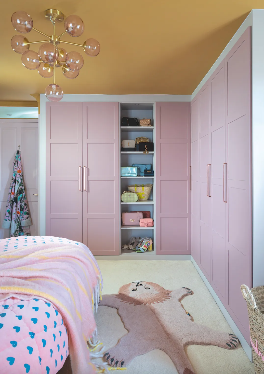 ‘I love the built-in wardrobes. They’re painted in my favourite colour – pink! – and they’re great for displaying my colourful collection of bags. They also add depth to the room’