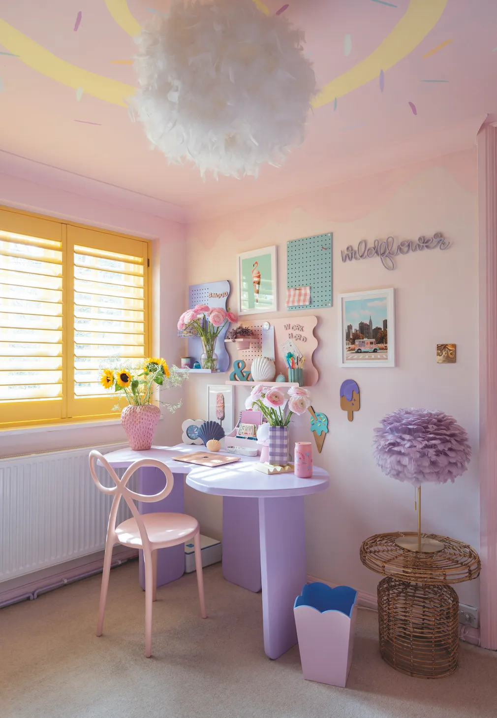 ‘The wavy lilac table is my favourite item in this room. It’s such a creative spot to work from. I brought texture to the scheme with these fun feather lampshades’