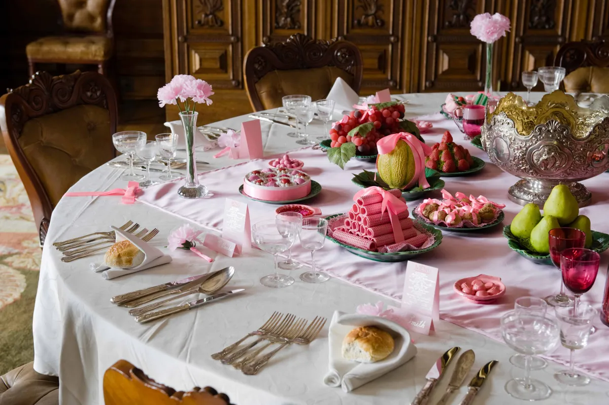 The Dining Room table with place settings, desserts and fruits at Kingston Lacy, Dorset