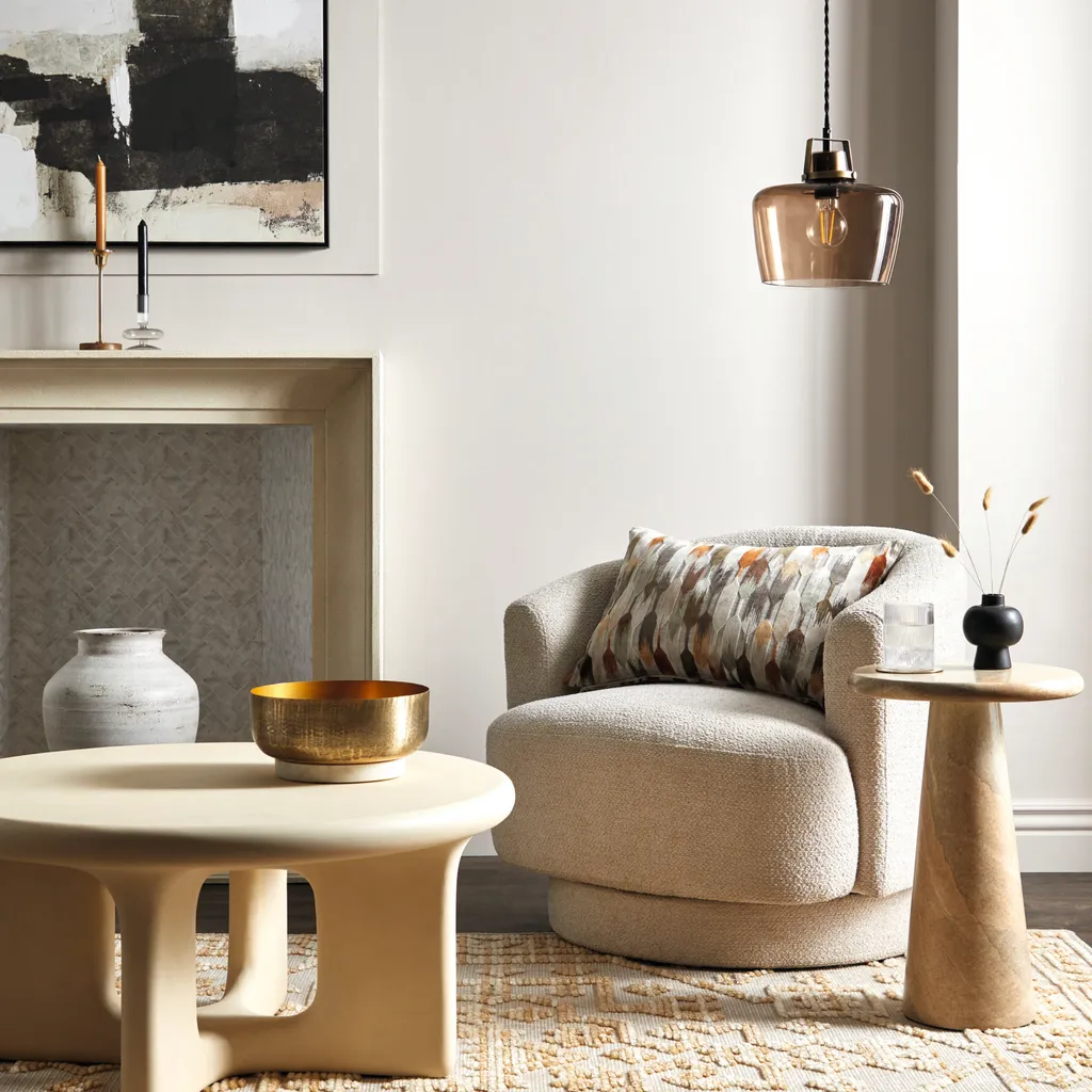 Carmen curved swivel chair in Chunky Ivory Chenille, £249; Rue coffee table, £379; Chiara side table, £249; Kelso cut velvet cushion in Natural, £25; Auburn single ceiling fitting, £35, all Dunelm