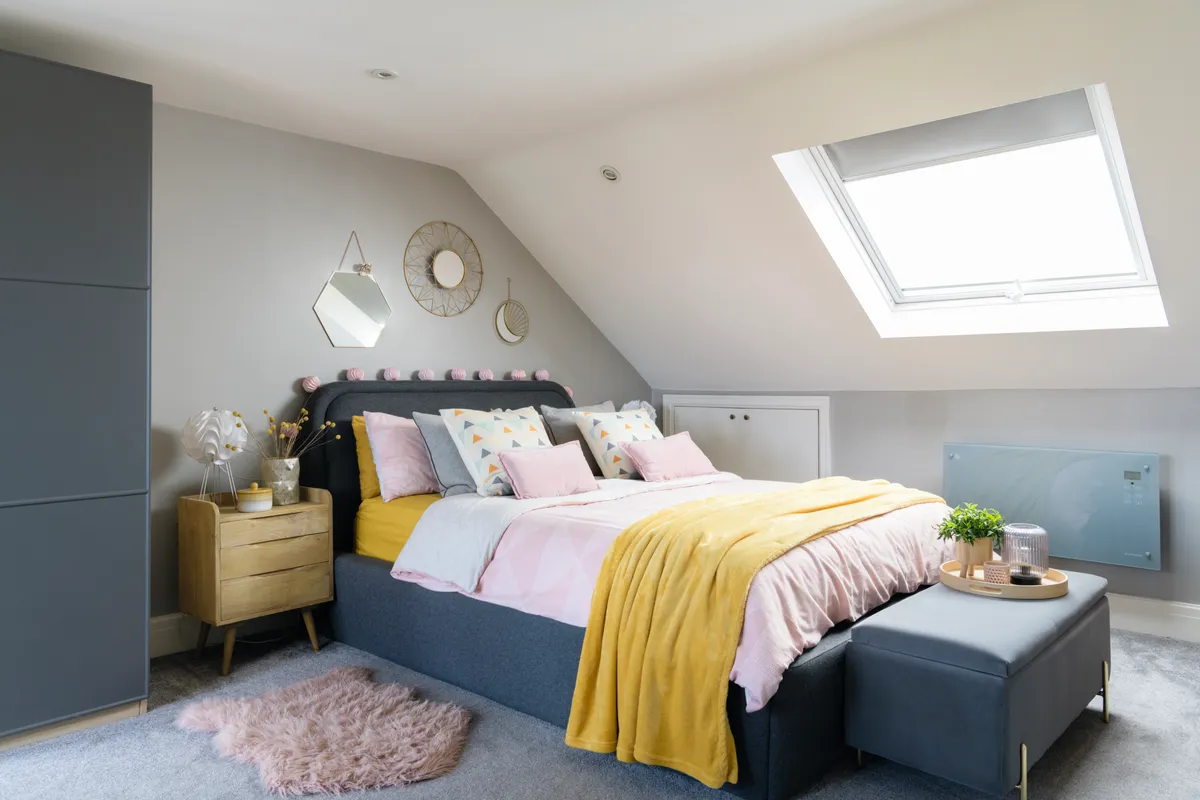 Attic bedroom with stylish bed and furnishings