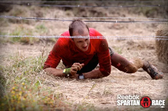 Jonathan Albon crawls through barbed wire