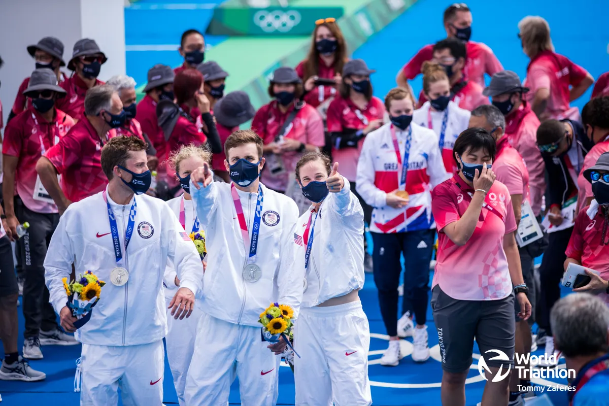 Team USA are delighted with their medals, Olympic individual bronze medallist Katrie Zaferes shares a moment with her husband photographer Tommy Zaferes behind the camera. 