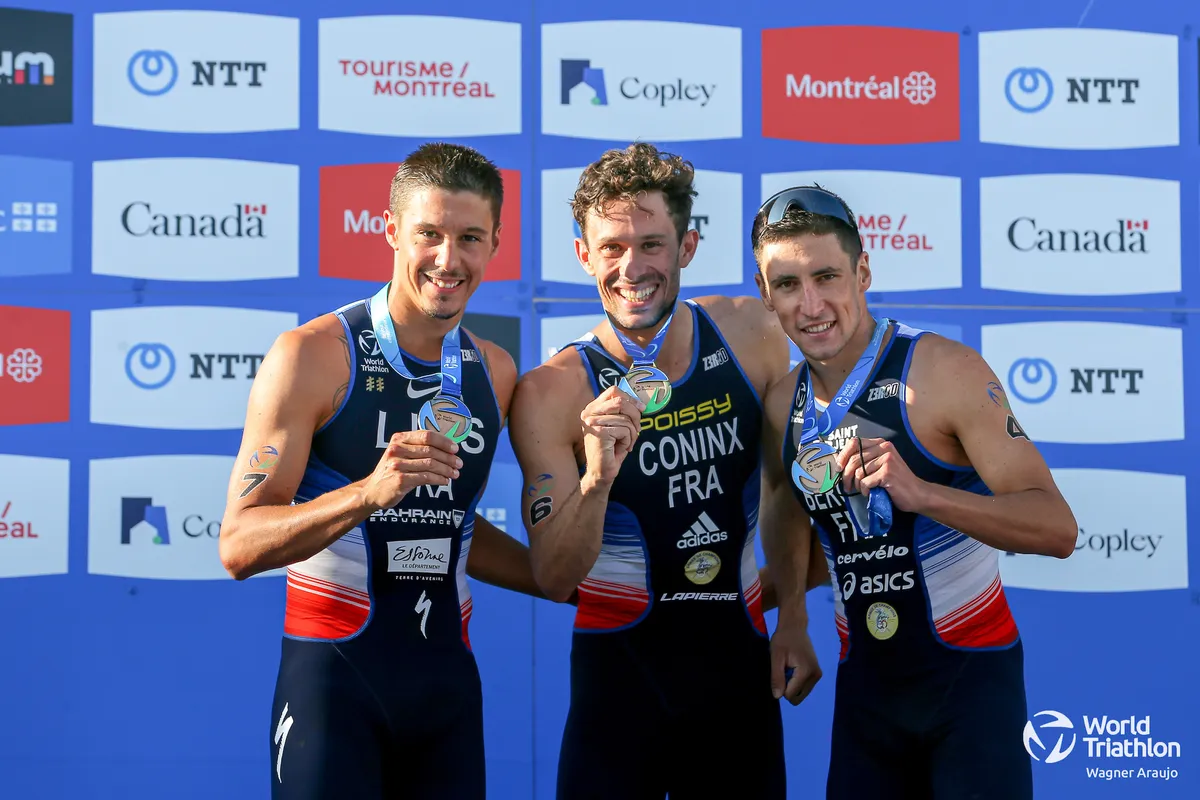 L-R: Vincent Luis (silver), Dorian Coninx (gold) and Leo Bergere (bronze) holding their respective medals on the podium of the 2021 Montreal World Triathlon race
