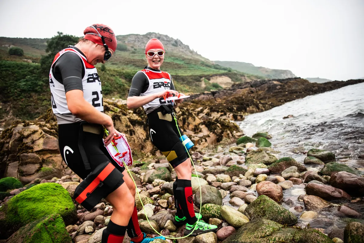Emily and Kate strap on their gear for a choppy sea swim / Andy Le Gresley Photography for Breca