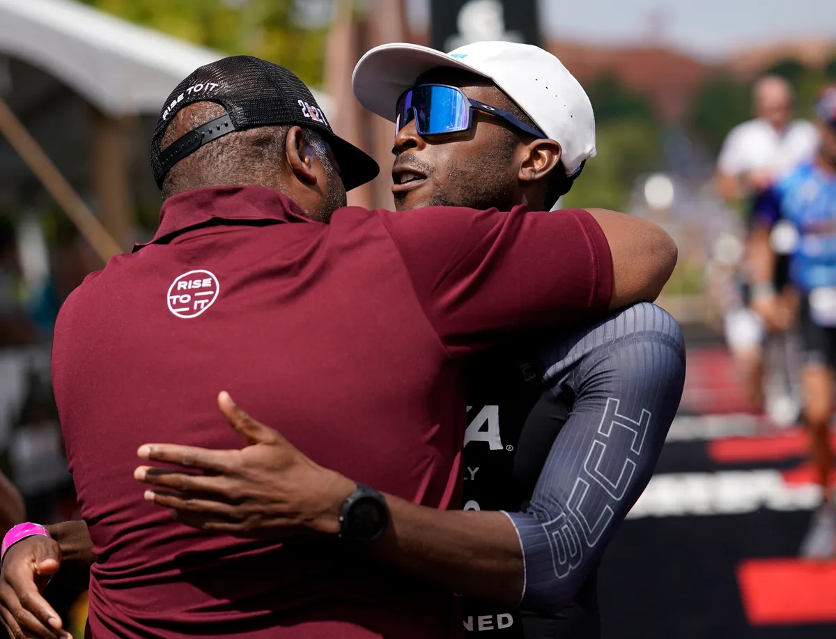 ST GEORGE, UTAH - SEPTEMBER 18: Sam Holness of England hugs his parents after finishing the Men's running leg during the IRONMAN 70.3 World Championship on September 18, 2021 in St George, Utah. (Photo by Patrick McDermott/Getty Images for IRONMAN)
