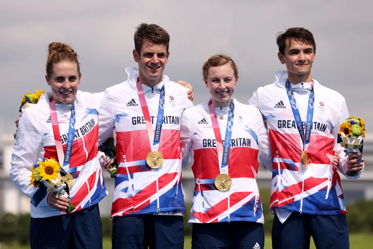 L-R: Jess Learmonth, Jonny Brownlee, Georgia Taylor-Brown and Alex Yee on the podium having won gold in the Tokyo Olympics Mixed Team Relay Triathlon event