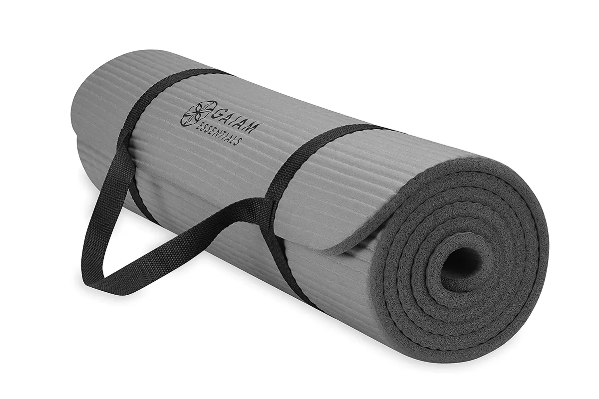 Grey thick yoga mat rolled up with strap