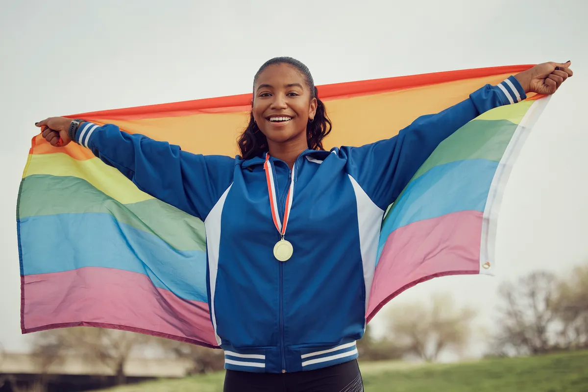 Athlete holding a rainbow flag