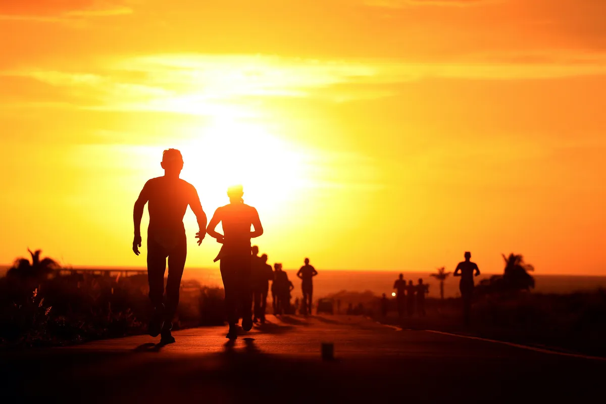 Triathletes run into the sunset during the Ironman World Championship in Kona, Hawaii