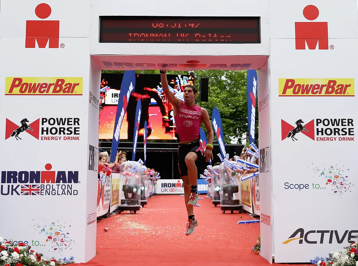 BOLTON, ENGLAND - AUGUST 04: Joe Skipper celebrates coming third during the Pro Mens Ironman during the Ironman UK on August 4, 2013 in Bolton, England. (Photo by Matthew Lewis/Getty Images)
