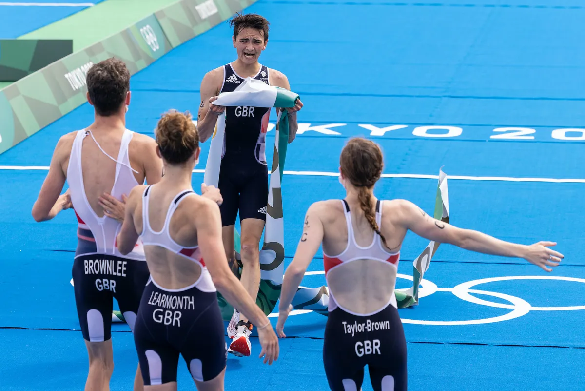 Team GB celebrates taking gold in the triathlon mixed relay at the Tokyo Olympics