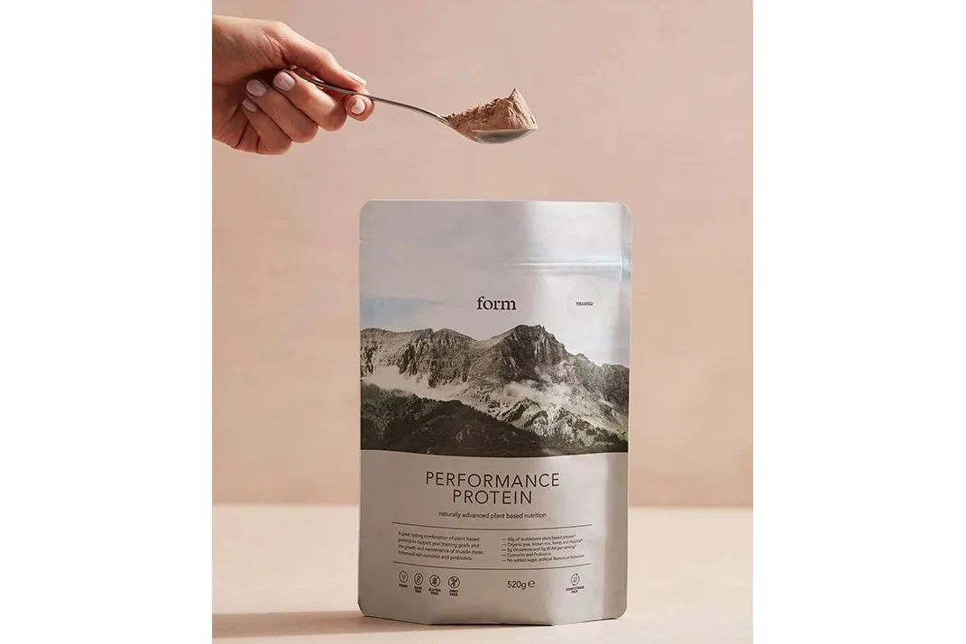 Form Vegan Protein Powder with someone holding a spoon of powder