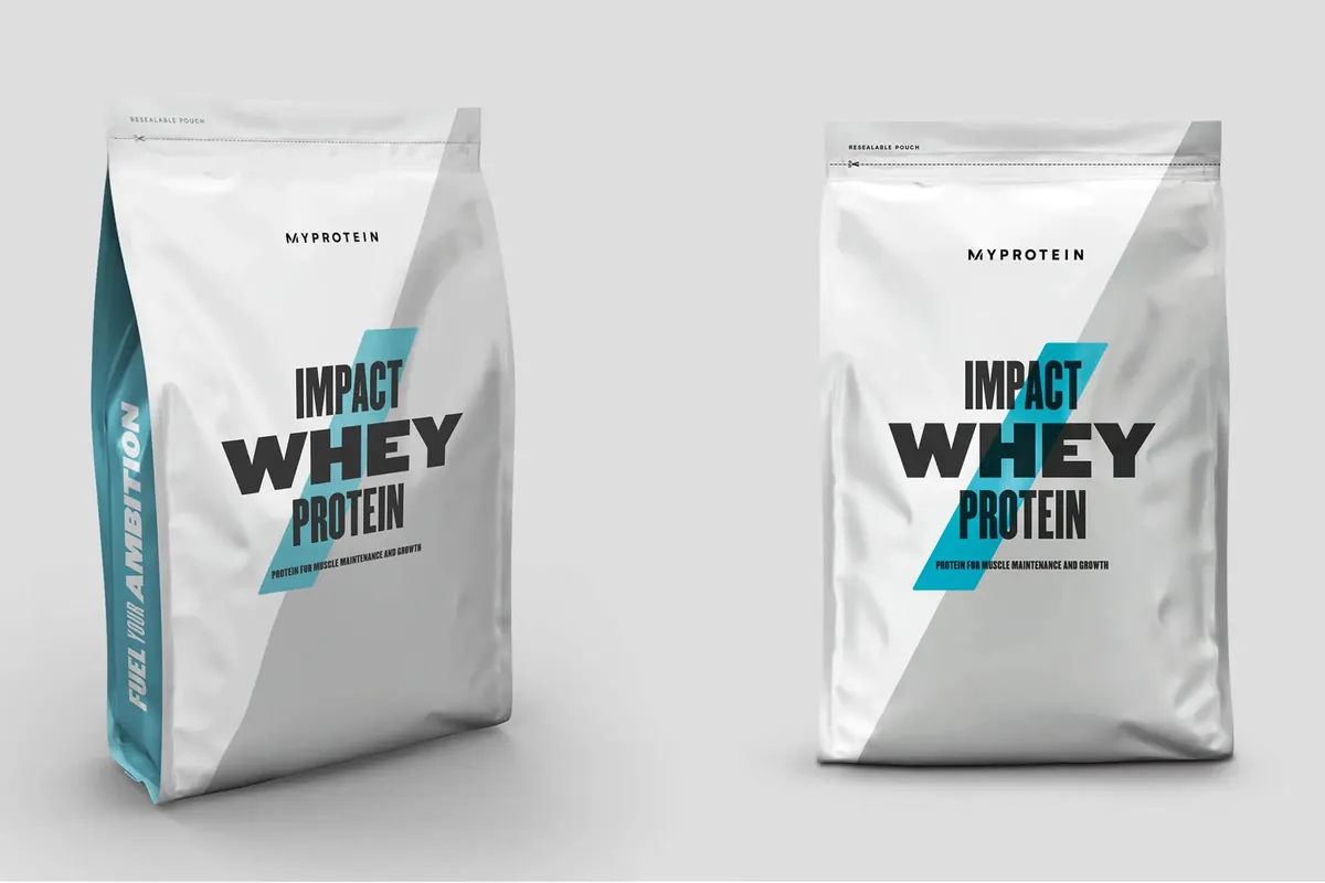Two bags of Myprotein Impact Whey Protein on a grey background
