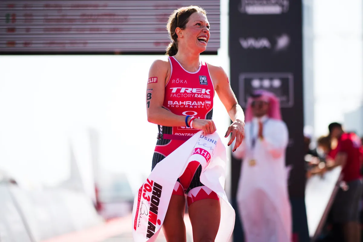 Holly Lawrence celebrates after winning Ironman 70.3 Bahrain in 2017