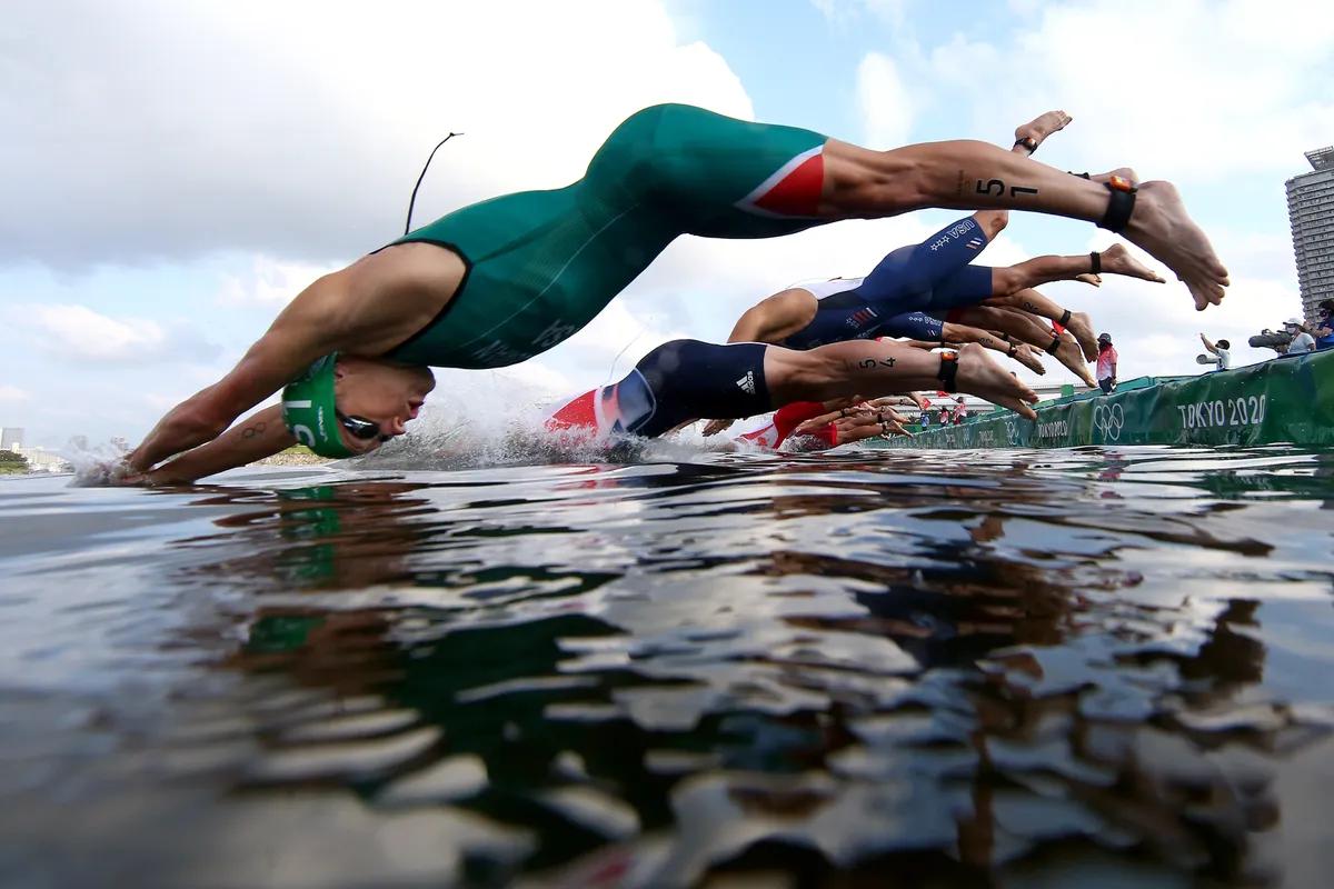 Henri schoeman dives into the water for the start of the Olympic sim leg