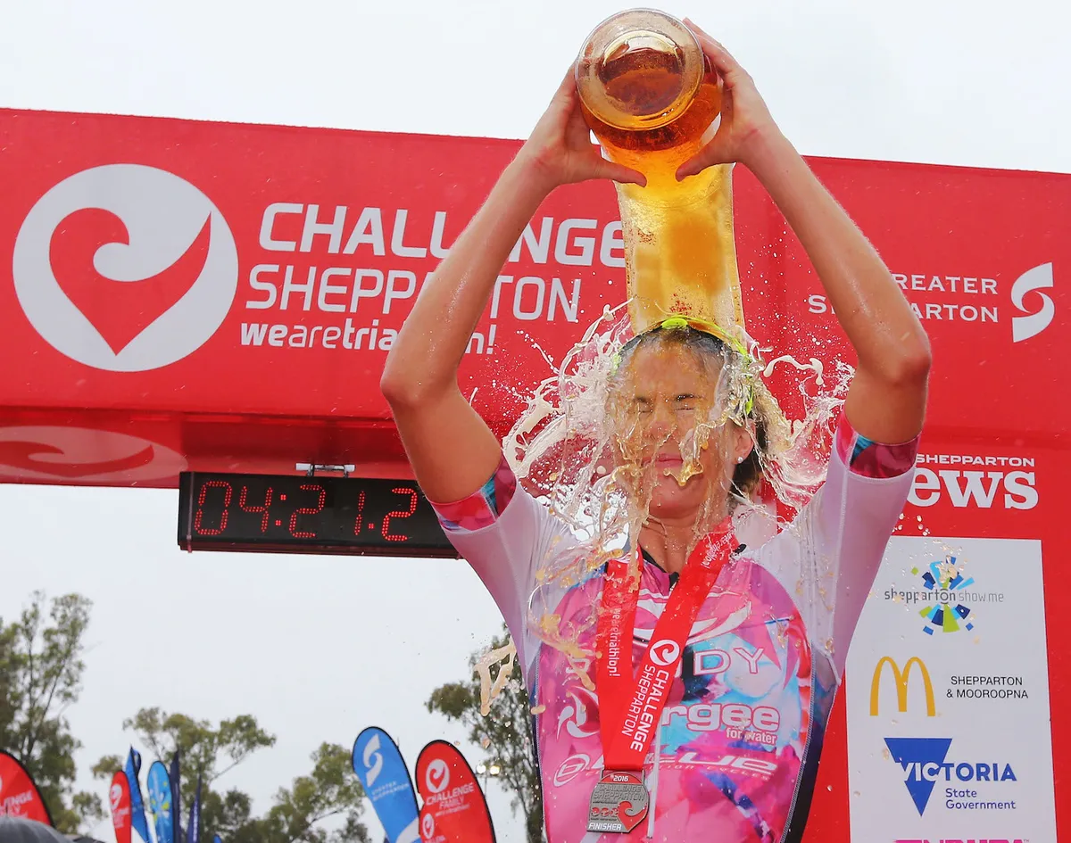 Triathlete Ellie Salthouse pours beer over herself after winning Challenge Shepperton