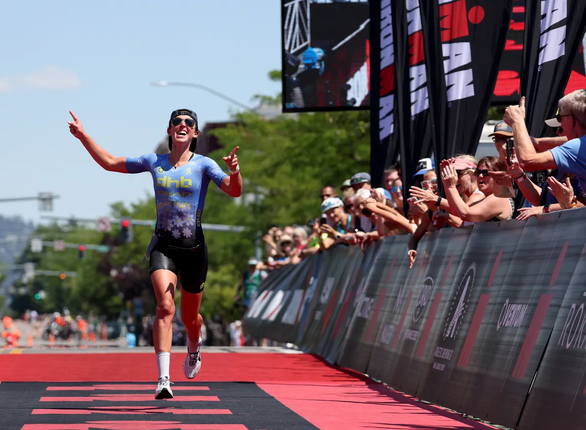 COEUR D'ALENE, IDAHO - JUNE 27: Fenella Langridge of Great Britain celebrates with fans as she approaches the finish line to for second place during IRONMAN Coeur d'Alene on June 27, 2021 in Coeur d'Alene, Idaho. (Photo by Harry How/Getty Images for IRONMAN)