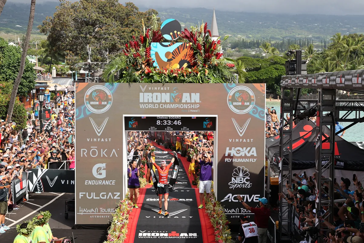Chelsea Sodaro celebrates winning the 2022 Ironman World Championship in Kailua Kona, Hawaii