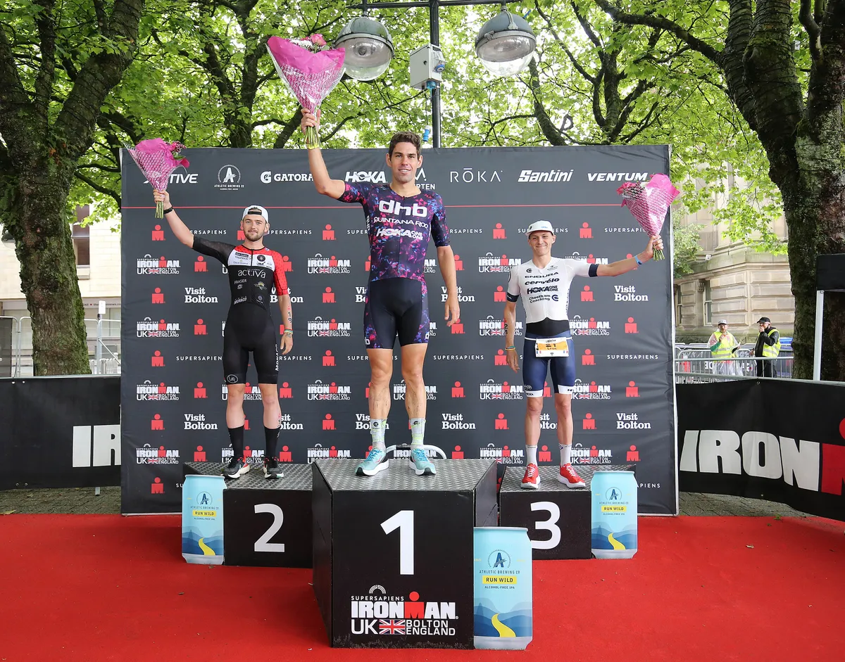 BOLTON, ENGLAND - JULY 04: Joe Skipper of Britain (C) 1st, Sam Laidlow of France (L) 2nd and Leon Chevalier of France (R) 3rd on the podium at Ironman UK on July 4, 2021 in Bolton, England. (Photo by Nigel Roddis/Getty Images for IRONMAN)