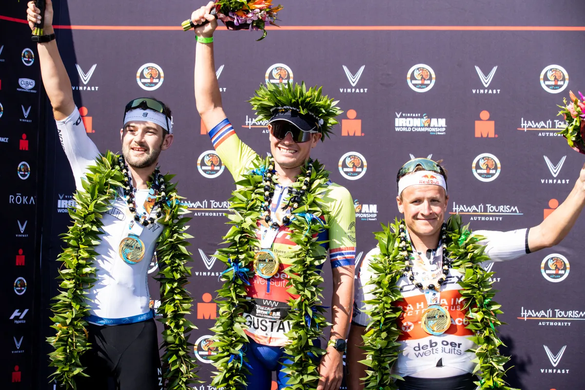 Norwegian Gustav iden 1st place French Sam Laidlow 2nd place Norwegian triathlete Kristian Blummenfelt and 3th place pictured at the podium after the Hawaii Ironman men's triathlon race, Saturday 08 October 2022, in Kailua, Kona, Hawaii, USA. BELGA PHOTO DAVID PINTENS (Photo by DAVID PINTENS / BELGA MAG / Belga via AFP) (Photo by DAVID PINTENS/BELGA MAG/AFP via Getty Images)
