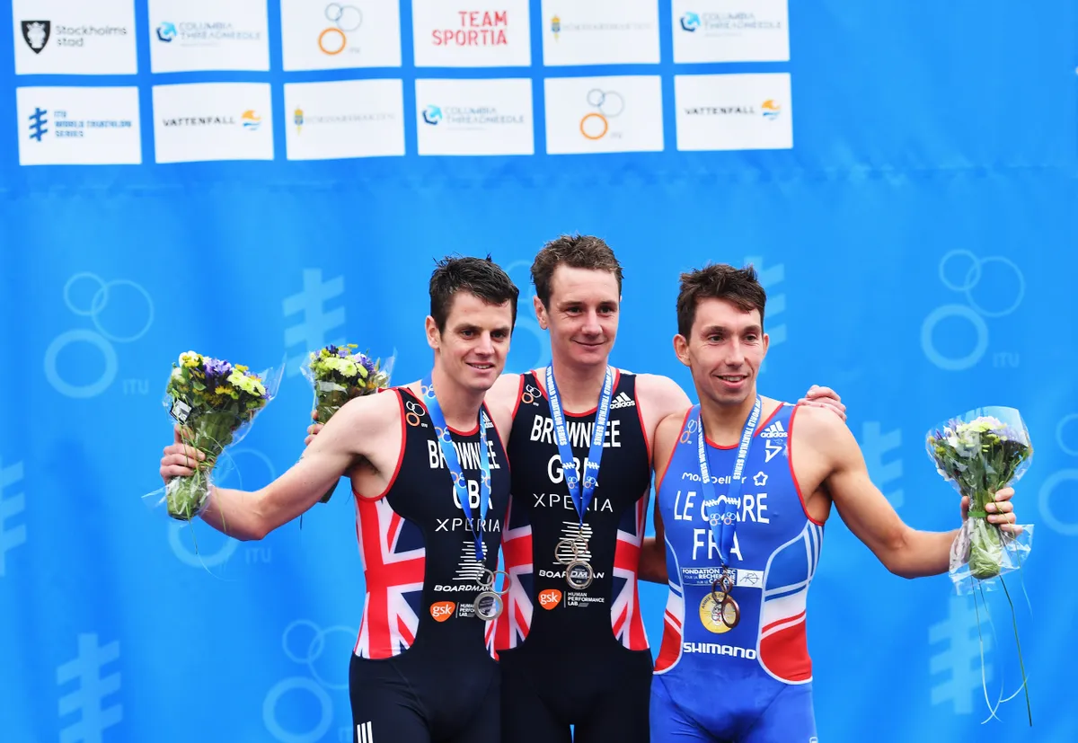 STOCKHOLM, SWEDEN - JULY 02: Alistair Brownlee of Great Britian celebrates winning with Jonathan Brownlee of Great Britian and Pierre Le Corre of France after the mens ITU World Triathlon Stockholm on July 2, 2016 in Stockholm, Sweden. (Photo by Stuart Franklin/Getty Images)