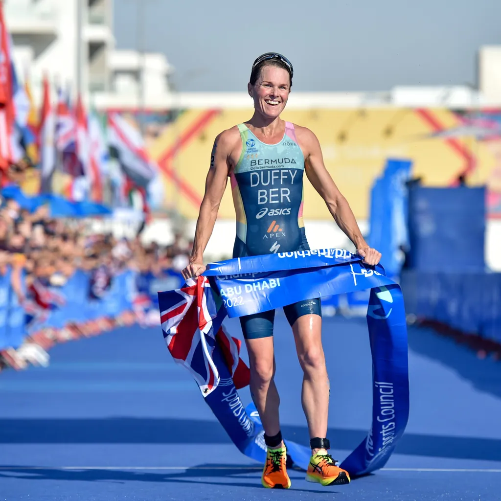 Bermudan triathlete Flora Duffy crosses the line at the 2022 World Triathlon Grand Final in Abu Dhabi to take her fourth world title